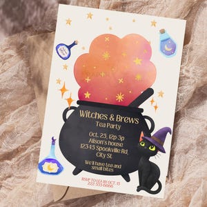 May include: A Halloween-themed invitation card with the text "Witches & Brews Tea Party." The design features a black cauldron, a black cat wearing a witch hat, and decorative stars and potion bottles. The card includes event details.