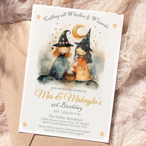 May include: A whimsical invitation card featuring two cartoon witches under a crescent moon and stars. The text reads "Calling all Witches & Wizards" and announces a 5th birthday party for Mia & Makayla. The card is on a beige envelope.