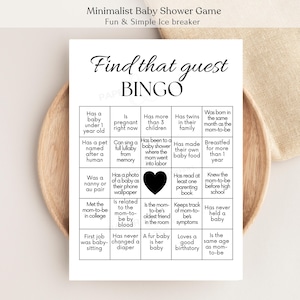 May include: A minimalist baby shower game card with the text "Find that guest BINGO." The card features a grid of statements like "Has a baby under 1 year old" and "Has twins in their family." The card is white with black text.