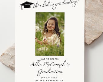 May include: Graduation announcement with a photo of a young girl in a field. The text reads "this kid is graduating!" and includes the name "Allie McCormik" and the date "June 11, 202X". The announcement is on a cream-colored background.