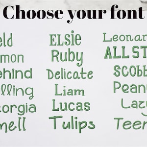 May include: A white display sheet featuring the black text Choose your font at the top, followed by three columns of green embroidered-style text samples including Field, Lemon, Behind, Falling, Georgia, Smell, ELSIE, Ruby, Delicate, Liam, Lucas, Tulips, Leonardo, ALL STAR, SCOBBY, Peanut, Lazy, and Teeny.