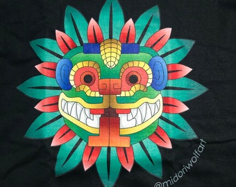 May include: A black t-shirt with a colorful graphic print of a stylized face with a flower-like design around it. The face is green, red, yellow, and blue. The text "@midoriwolfart" is printed on the bottom right corner of the shirt.