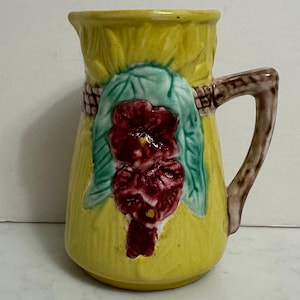 May include: A set of three ceramic mugs with a speckled, matte finish. The mugs are in shades of cream, light gray, and dark gray. Each mug has a simple, minimalist design, perfect for coffee or tea.