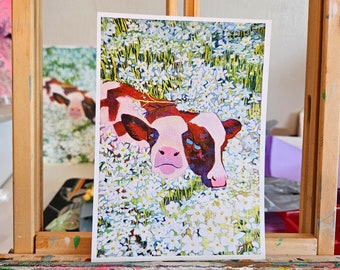 May include: A painting of a brown and white calf lying in a field of white flowers. The calf's eyes are closed and its mouth is slightly open. The flowers are in full bloom and the background is a blur of green.