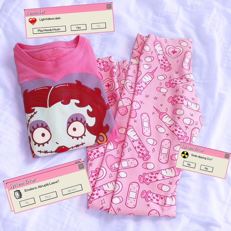 May include: Pink pajama set featuring a Betty Boop graphic tee and matching leggings. The leggings have a pattern of syringes, bandages, and pills. The tee has the text "Betty Boop". The image also includes pop-up windows with text.
