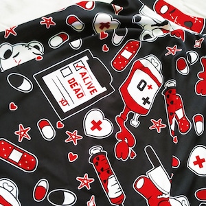 May include: Black fabric with a repeating pattern of red and white medical symbols, including a blood bag, a syringe, a bandage, a heart, and a checklist with the words "Alive" and "Dead".