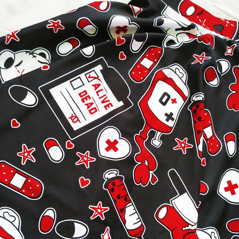May include: Black fabric with a repeating pattern of red and white medical symbols, including a blood bag, a syringe, a bandage, a heart, and a checklist with the words "Alive" and "Dead".