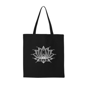 May include: Black tote bag with a white mandala-style lotus flower design.