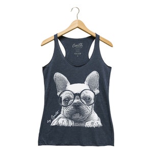 May include: A navy blue tank top with a white graphic of a French bulldog wearing glasses. The text "by Couth" is printed on the bottom left corner of the graphic.