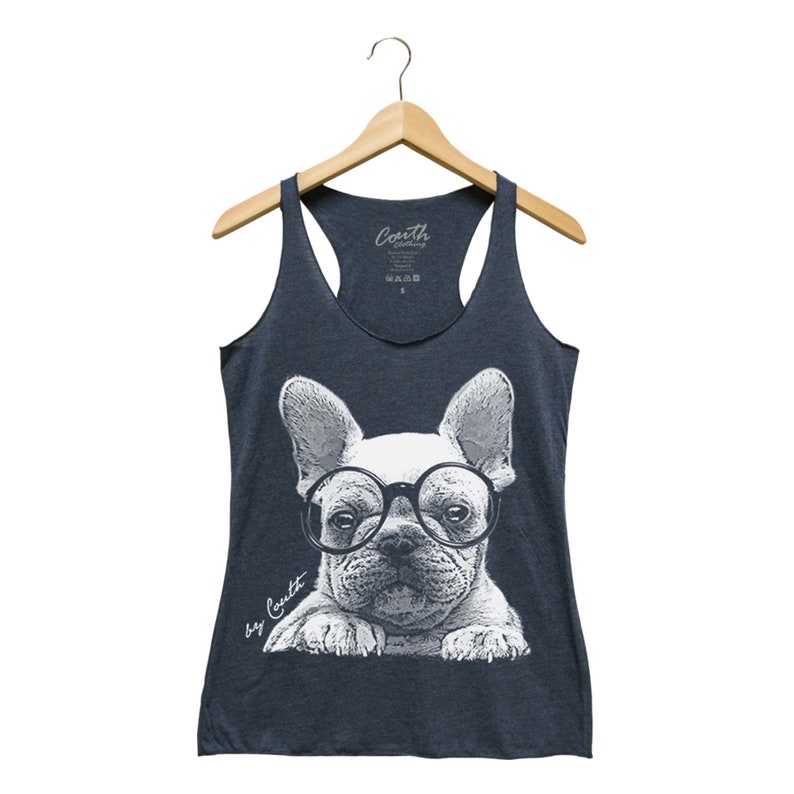 May include: A navy blue tank top with a white graphic of a French bulldog wearing glasses. The text "by Couth" is printed on the bottom left corner of the graphic.
