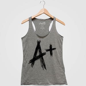 May include: Gray tank top with a black and white graphic of the letter A with a plus sign. The text "Youth Clothing" is on the tag.