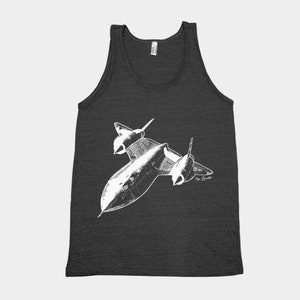 May include: A dark gray tank top with a white illustration of a SR-71 Blackbird aircraft. The illustration is in a vintage style and includes the text "by Cowelt".