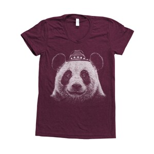 May include: A maroon t-shirt featuring a white graphic of a panda wearing a cowboy hat.