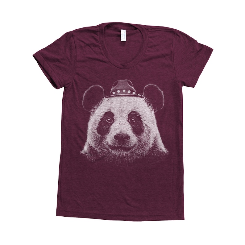 May include: A maroon t-shirt featuring a white graphic of a panda wearing a cowboy hat.