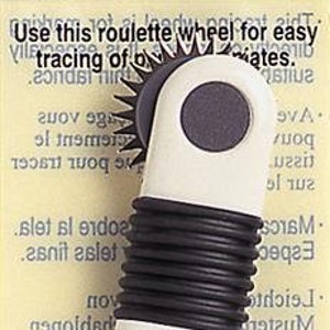 May include: White tracing wheel with a black handle and serrated edges. The wheel is used for tracing patterns on fabric. The packaging says "Tracing Wheel (Serrated Edges)" and "Art No. 480/W".