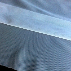 May include: A close-up of two pieces of fabric. The top piece is a light blue sheer fabric with a subtle ribbed texture. The bottom piece is a dark blue fabric with a fine, vertical ribbed texture.