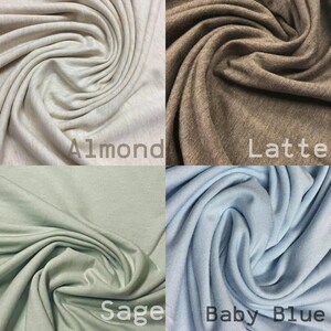 May include: Four fabric swatches in different colors: Almond, Latte, Sage, and Baby Blue. The fabric is soft and has a slight texture.