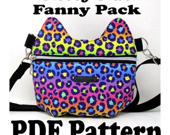 Könnte beinhalten: Ein PDF-Muster für eine regenbogenfarbene Leoparden-Fanny-Pack in Katzenform. Das Muster enthält einen schwarzen Gurt und zwei Reißverschlussfächer.