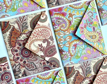 May include: A set of six colorful patterned envelopes with a paisley design. The envelopes are folded in half and have a flap on the top. The patterns are a mix of blue, green, yellow, pink, and brown.