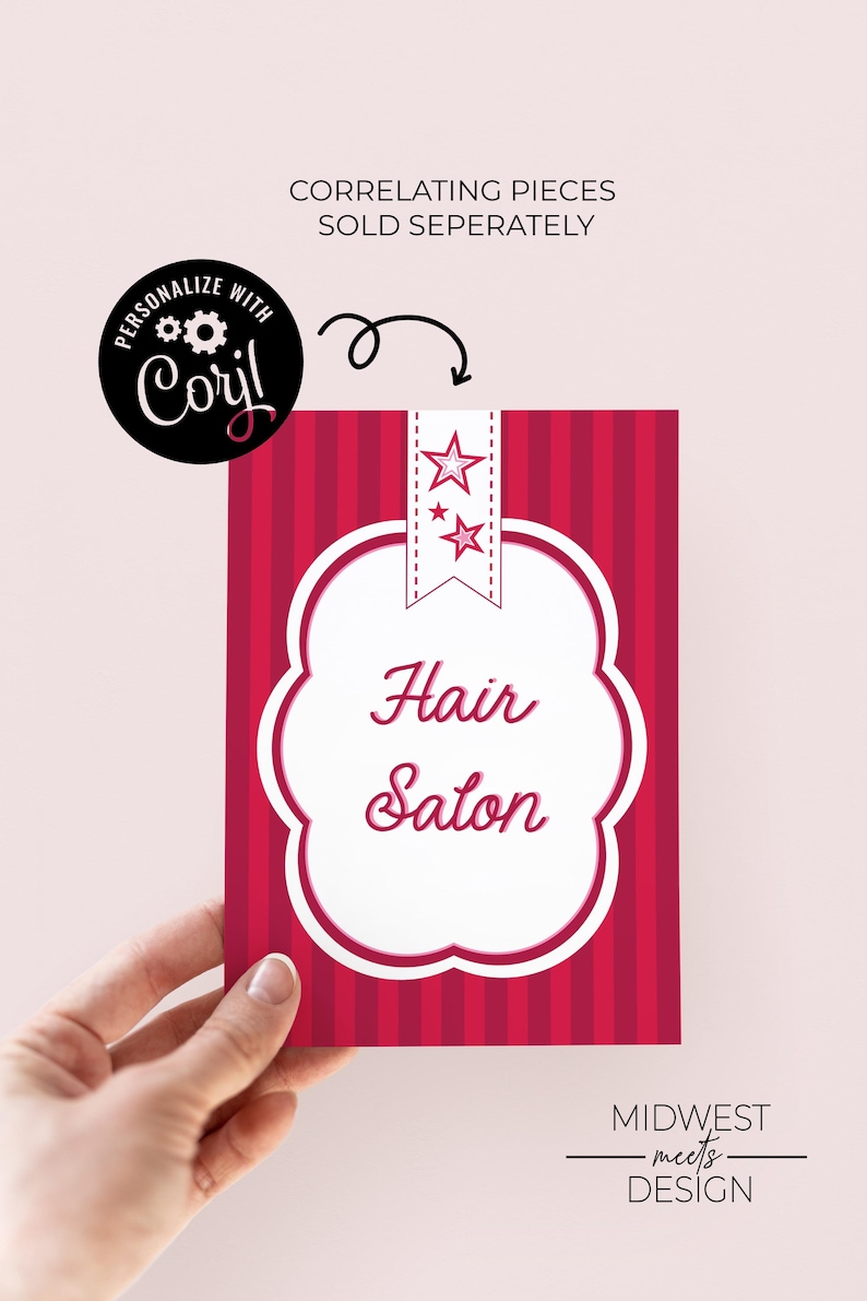 May include: A red and white sign for a hair salon, held by a hand. The sign has a white, cloud-shaped border with the words "Hair Salon" in cursive. The background is red with vertical stripes. The sign also has a star design.