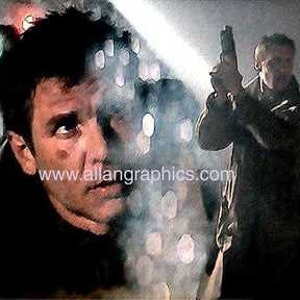 May include: A man with dark hair and a beard is looking to the right. He is wearing a dark jacket and a white shirt. He is partially obscured by smoke. A second man is standing behind him, holding a gun and looking to the left. He is wearing a dark jacket and a dark shirt. The background is a dark, smoky room.