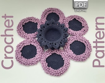 May include: A crochet flower pattern with six purple and gray coasters and a center piece. The pattern is available as a digital PDF download.
