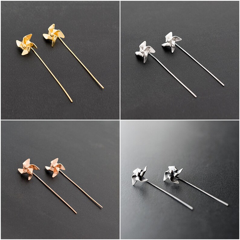 May include: Four pairs of pinwheel-shaped earrings in gold, silver, and rose gold tones. Each earring features a pinwheel design atop a long, slender post. The earrings are displayed against a dark grey background.