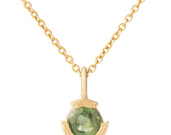 May include: A gold necklace with a green gemstone pendant. The pendant is set in a gold setting with a textured design.