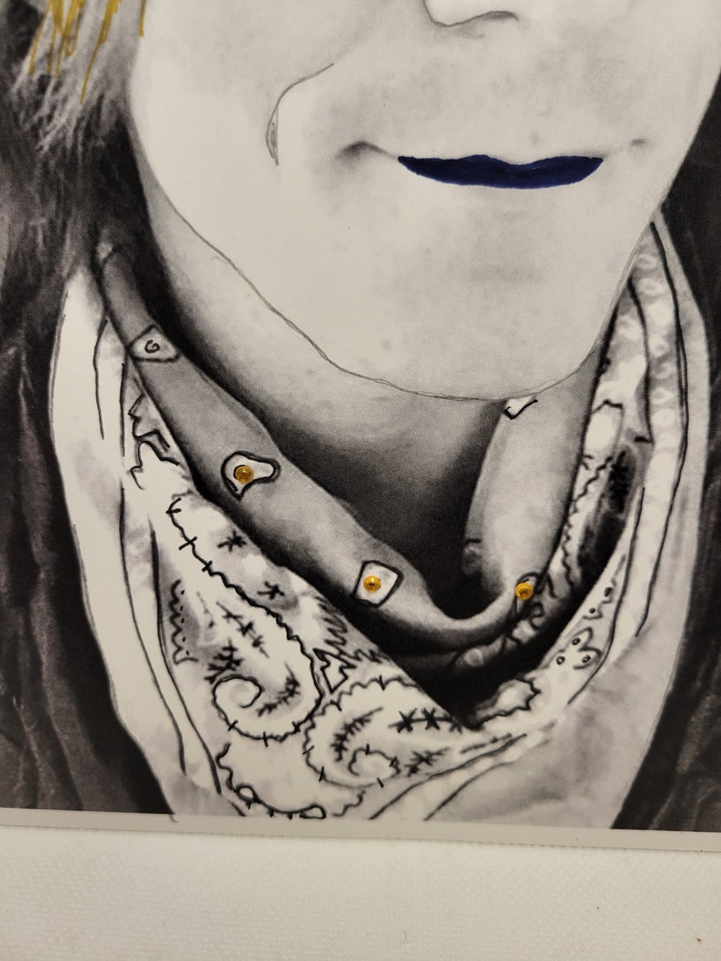 May include: A black and white drawing of a person wearing a bandana with gold accents. The bandana has a paisley pattern and is tied around the person's neck. The person's lips are painted a dark blue colour.