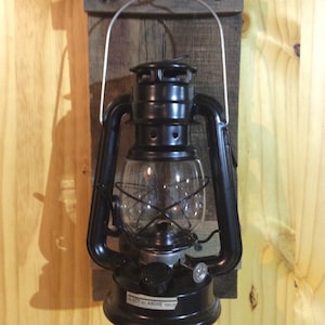 Lantern wall sconce. Made from reclaimed wood and rustic oil lantern makes these a great addition to any home