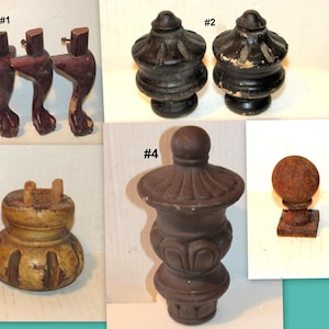 May include: A collection of antique wooden furniture parts, including four cabriole legs, two finials, two bun feet, a decorative urn-shaped piece, and three ball-shaped finials on square bases. The pieces are in various shades of brown and show signs of age.