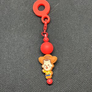 May include: A handmade wooden sign with the text "Welcome" in a playful font. The sign is painted white with a distressed finish, and features a decorative floral design in shades of pink and green. It is designed for indoor or outdoor use.