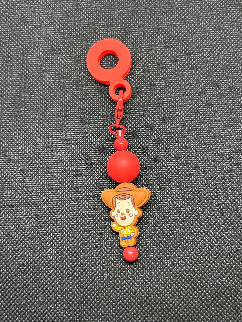 May include: A handmade wooden sign with the text "Welcome" in a playful font. The sign is painted white with a distressed finish, and features a decorative floral design in shades of pink and green. It is designed for indoor or outdoor use.