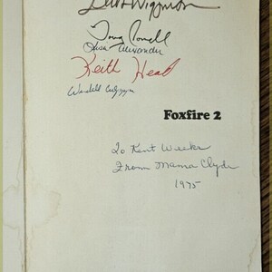 May include: A white page with black ink signatures from various people. The signatures include "Elin Wigjimn", "Domy lovell", "Aisa Ausandn", "Reith Heal", and "Wendell Cugnayan". The page also includes the text "Foxfire 2", "Lo Kent Weekr", "From Mama Clyde", and "1975".