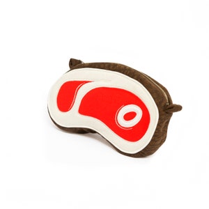 May include: A brown fabric pouch shaped like a steak. The steak is red and white with a white outline. The pouch has a zipper closure.