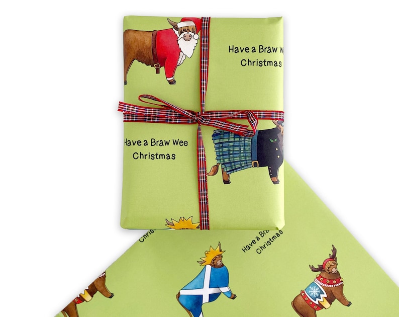 May include: Green wrapping paper featuring a festive Scottish Highland cow design. The cow is wearing a Santa hat and a red suit. The text "Have a Braw Wee Christmas" is printed on the paper.