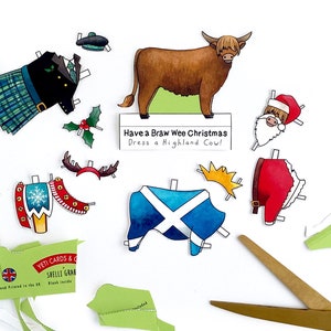 May include: A paper craft kit featuring a Highland cow with a variety of festive outfits, including a kilt, a Santa suit, and a Scottish flag. The kit includes the text "Have a Braw Wee Christmas Dress a Highland Cow!"
