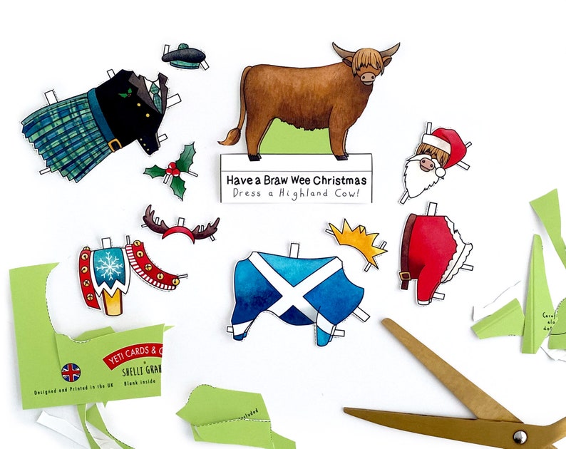 May include: A paper craft kit featuring a Highland cow with a variety of festive outfits, including a kilt, a Santa suit, and a Scottish flag. The kit includes the text "Have a Braw Wee Christmas Dress a Highland Cow!"