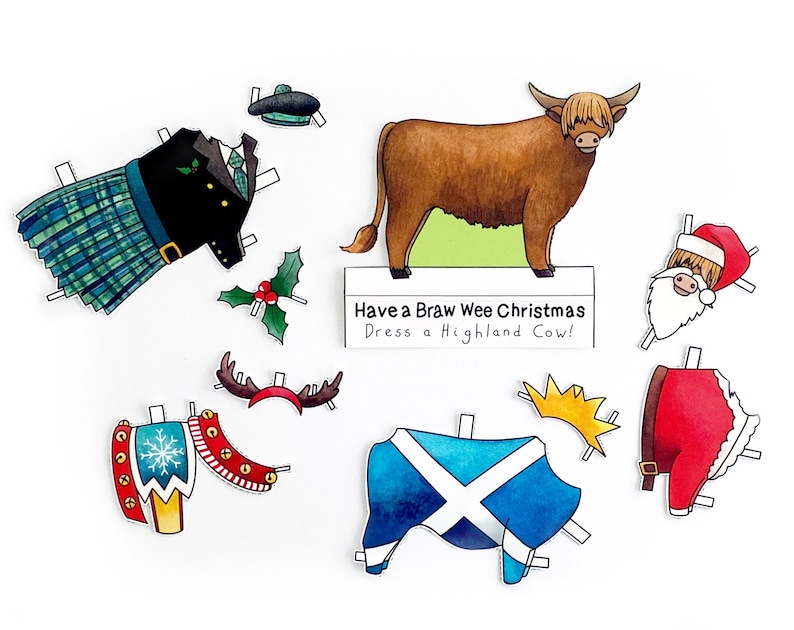 May include: A paper doll set featuring a Highland cow with various outfits, including a kilt, a Santa suit, and a Scottish flag. The text on the sign reads "Have a Braw Wee Christmas Dress a Highland Cow!"