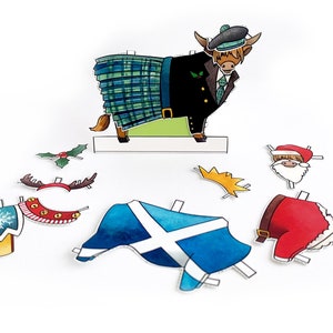 May include: A paper craft set featuring a Highland cow wearing a kilt, a Santa hat, and a crown. The set also includes a Scottish flag, a holly sprig, reindeer antlers, and a Santa suit.