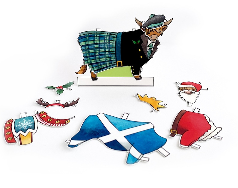 May include: A paper craft set featuring a Highland cow wearing a kilt, a Santa hat, and a crown. The set also includes a Scottish flag, a holly sprig, reindeer antlers, and a Santa suit.