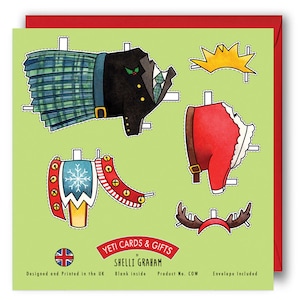 May include: A green card with a paper doll design featuring a Santa Claus, a Scottish man, and a reindeer. The card has the text "YETI CARDS & GIFTS by SHELLI GRAHAM" and "Designed and Printed in the UK. Blank inside. Product No. COW. Envelope Included."