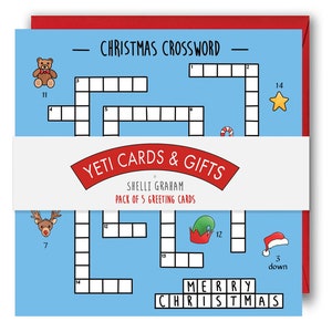 May include: A pack of 5 Christmas greeting cards featuring a blue background with a crossword puzzle and the text "Merry Christmas". The cards are designed by Shelli Graham and are part of the Yeti Cards & Gifts collection.