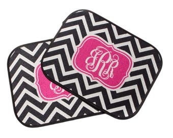 May include: Two black and white chevron patterned floor mats with pink monogrammed labels. The monogram is in a white script font and reads "SPR".