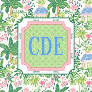 mahjong mat A decorative square with the letters "CDE" in blue, set against a green patterned background. The square is framed in pink and surrounded by a tropical floral design with palm trees, flowers, and small buildings.