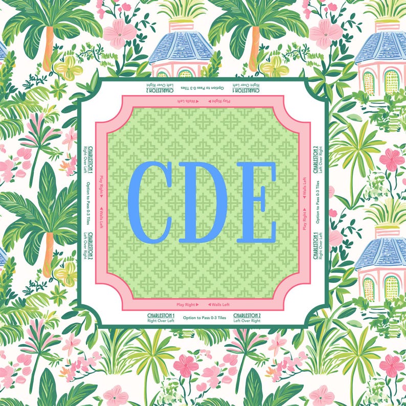 mahjong mat A decorative square with the letters "CDE" in blue, set against a green patterned background. The square is framed in pink and surrounded by a tropical floral design with palm trees, flowers, and small buildings.