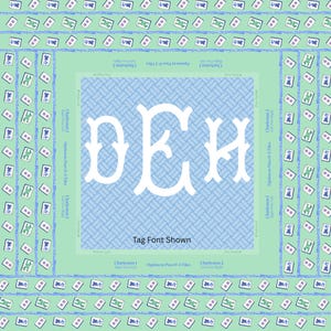 May include: A square, light green and blue Mahjong tile design with a central monogram in white. The design includes the text "Tag Font Shown" and other text related to the game.
