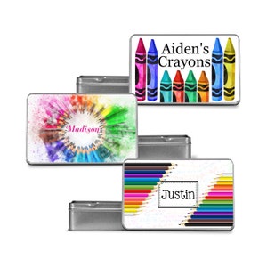 May include: Four metal tins with different designs featuring colorful crayons and pencils. The tins are labeled with the names "Aiden's Crayons", "Madison", "Justin", and a blank tin.