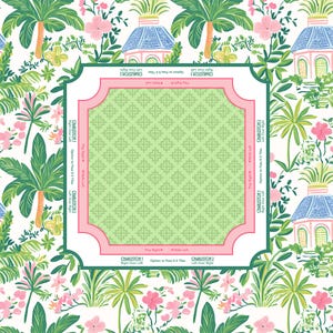 A decorative mah jongg mat with a tropical floral design. The background features palm trees, pink flowers, and small blue-roofed buildings. A central square with a green geometric pattern is framed in pink, with text that reads "Charleston".