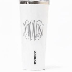 May include: White insulated tumbler with a silver rim and lid. The tumbler features a gray monogram design and the brand name "corkcicle." The tumbler is designed to keep beverages cold or hot.